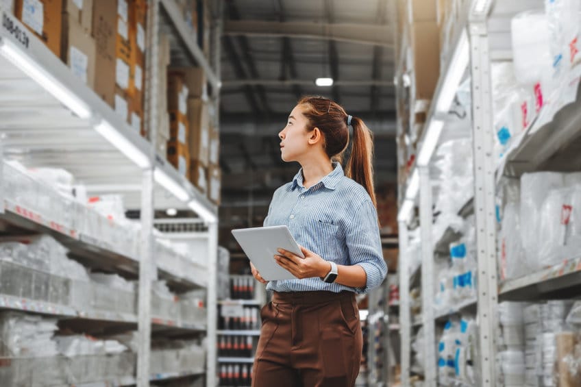 Asian woman worker working with digital tablet checking boxes Lo